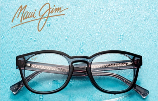 Maui Jim Eyewear - Webster Eye Doctor | Clear Lake Eye Center A pair of stylish Maui Jim eyeglasses rests on a textured blue surface with water droplets. - Webster Eye Doctor | Clear Lake Eye Center